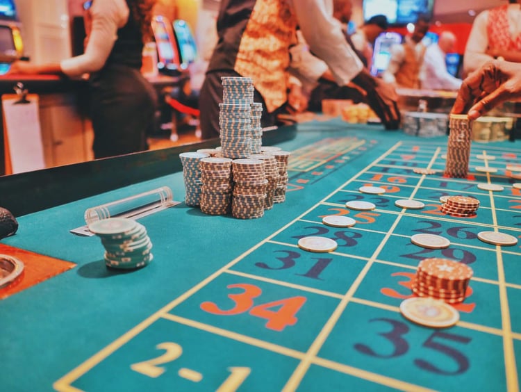 CAVU HCM. Gambling winnings on table in casino.